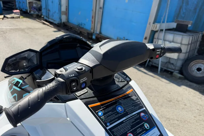 Slide: The Image of 2022 Yamaha WaveRunner VX Cruiser handlebars with control buttons, parked outdoors. - 7