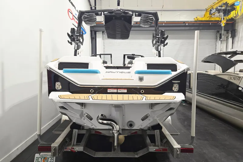 Slide: The Image of 2026 Nautique Super Air Nautique S21 boat on trailer in indoor storage. - 5