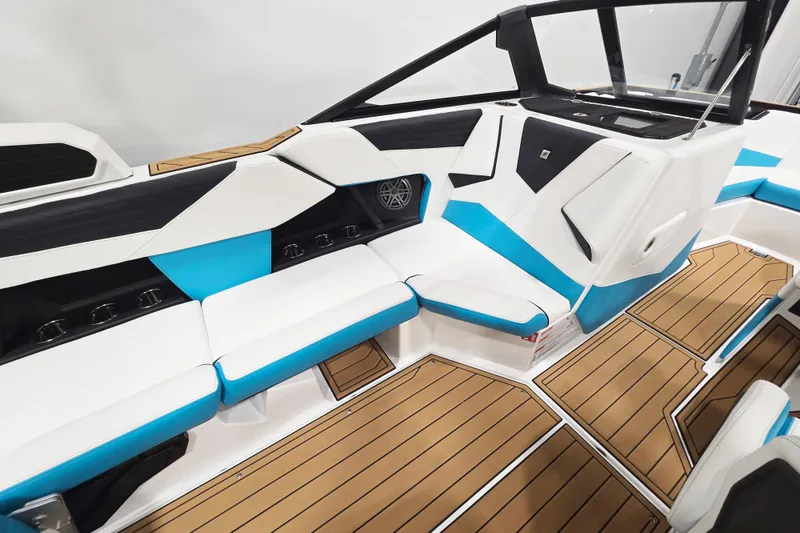 Slide: The Image of 2026 Nautique Super Air Nautique S21 interior with white and blue seating, teak flooring. - 7