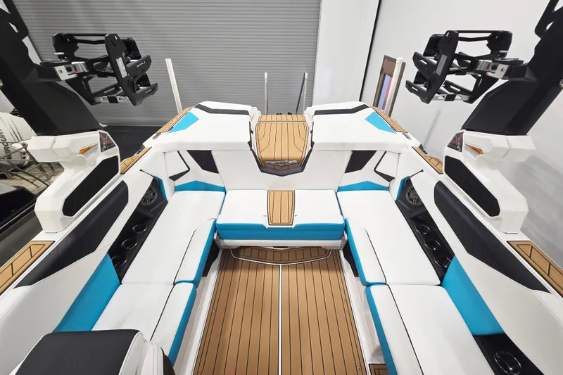 Slide: The Image of 2026 Nautique Super Air Nautique S21 interior with white and blue seating, wood accents. - 9