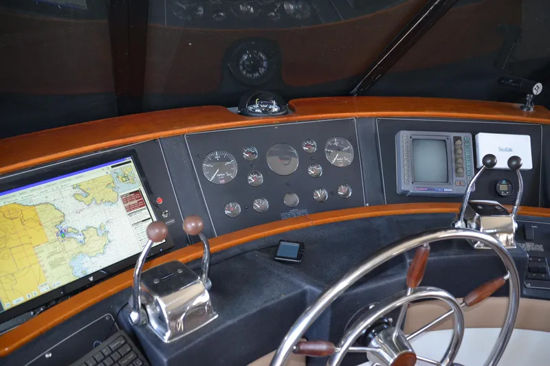 Slide: The Image of 1994 Bayliner 4788 Pilot House Motoryacht helm with navigation equipment and steering wheel. - 4