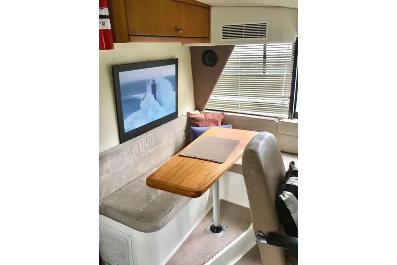 Slide: The Image of Interior of 1994 Bayliner 4788 Pilot House Motoryacht with seating and table. - 6