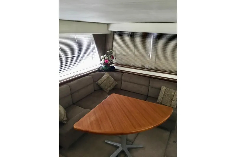 Slide: The Image of Interior of 1994 Bayliner 4788 Pilot House Motoryacht with cozy seating and wooden table. - 8