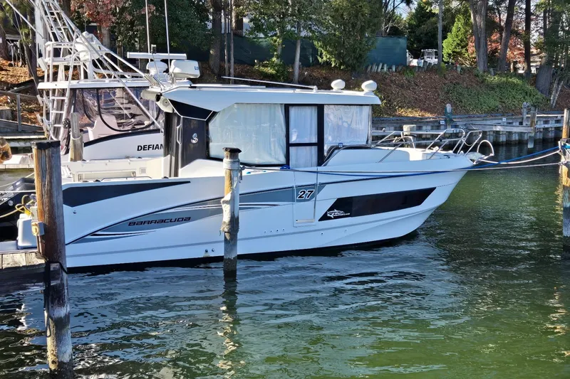 The Image of 2020 Beneteau Barracuda 27 docked in a serene marina setting. - 0