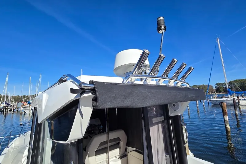 Slide: The Image of 2020 Beneteau Barracuda 27 boat with radar and rod holders, docked in a marina. - 2