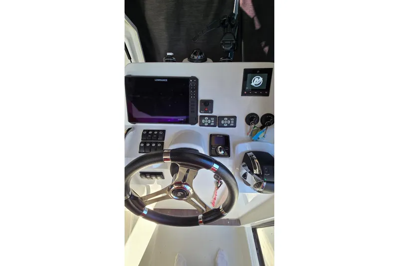 Slide: The Image of Cockpit of 2020 Beneteau Barracuda 27 with steering wheel and navigation controls. - 4