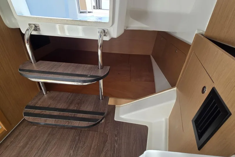 Slide: The Image of Interior view of 2020 Beneteau Barracuda 27 boat with wooden steps and storage area. - 5