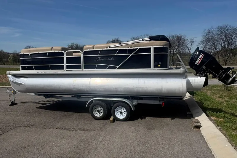 Slide: The Image of 2018 Sweetwater 2286 Cruise pontoon boat on trailer, parked outdoors. - 3