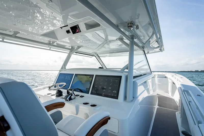 Slide: The Image of 2023 Yellowfin 54 boat cockpit with advanced navigation system on open water. - 44