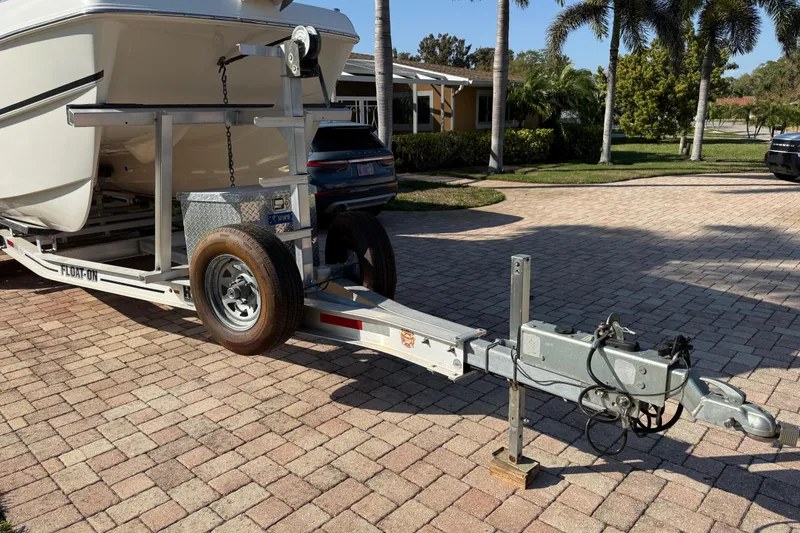 Slide: The Image of 2014 Carolina Cat 23DC boat on trailer in sunny driveway setting. - 10
