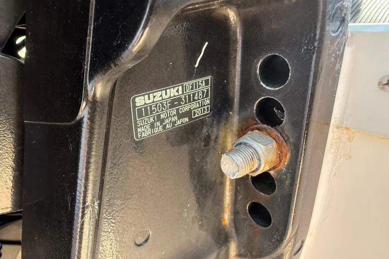 Slide: The Image of Close-up of Suzuki motor part with serial number on a 2014 Carolina Cat 23DC. - 18