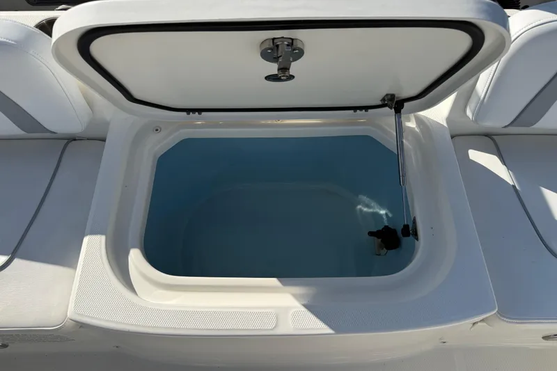 Slide: The Image of Open storage compartment on a 2014 Carolina Cat 23DC boat. - 22