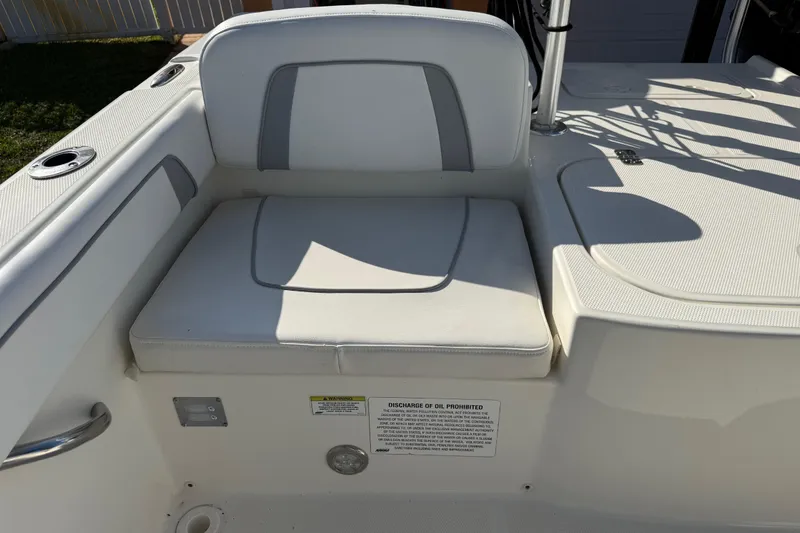 Slide: The Image of 2014 Carolina Cat 23DC boat seat with white upholstery and storage compartment. - 24