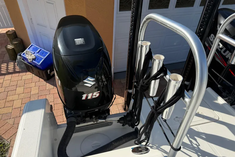 Slide: The Image of 2014 Carolina Cat 23DC boat with Suzuki 115 outboard motor and rod holders. - 26