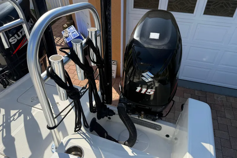 Slide: The Image of 2014 Carolina Cat 23DC boat with Suzuki 115 outboard motor and rod holders. - 28