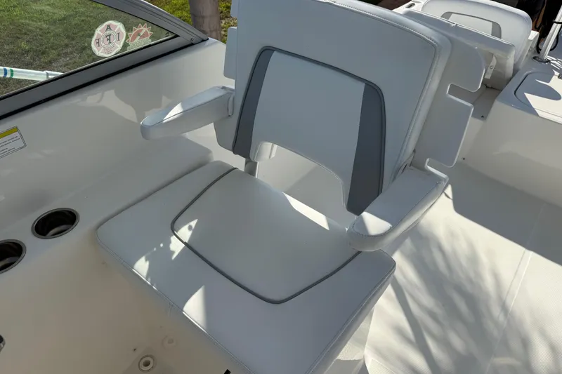 Slide: The Image of White seating area on a 2014 Carolina Cat 23DC boat with cup holders. - 33