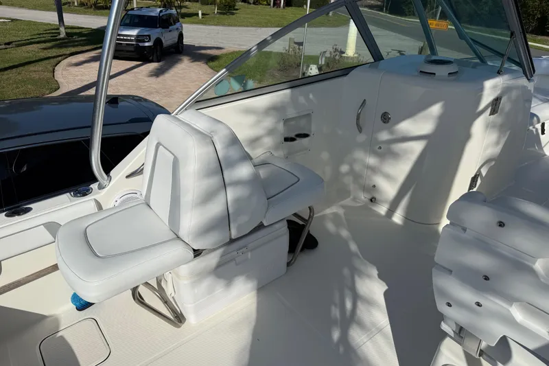 Slide: The Image of 2014 Carolina Cat 23DC boat interior with white seating and console. - 34
