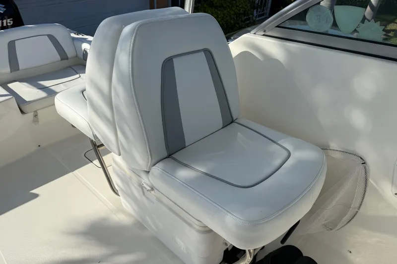 Slide: The Image of 2014 Carolina Cat 23DC boat interior with white cushioned seating. - 35
