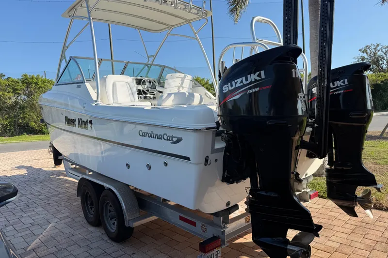 Slide: The Image of 2014 Carolina Cat 23DC boat with dual Suzuki outboard motors on a trailer. - 4