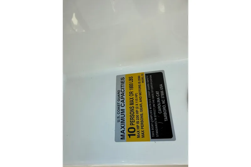 Slide: The Image of Capacity label on 2014 Carolina Cat 23DC boat, indicating 10-person or 1800 lbs limit. - 44