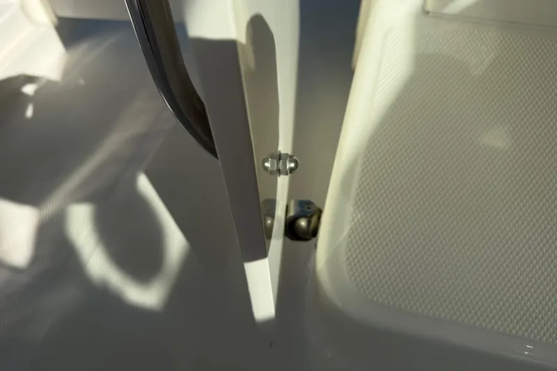 Slide: The Image of Close-up of a 2014 Carolina Cat 23DC boat hinge and textured flooring. - 46