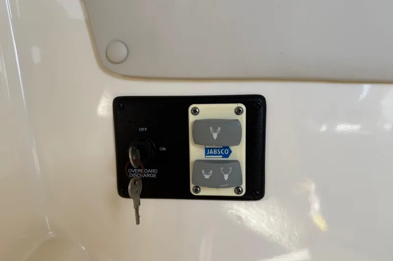 Slide: The Image of Control panel with Jabsco switches on a 2014 Carolina Cat 23DC boat. - 49
