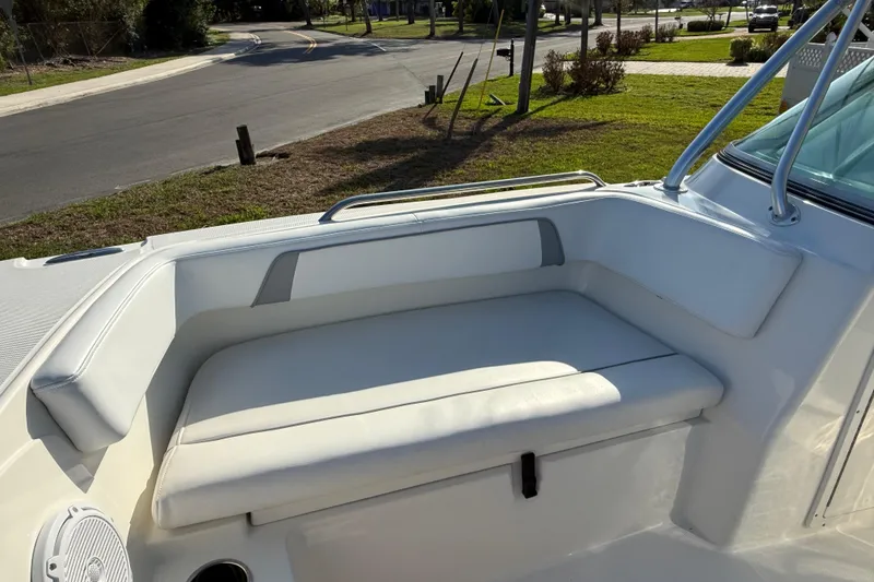 Slide: The Image of 2014 Carolina Cat 23DC boat interior with white cushioned seating and railing. - 56