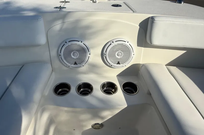 Slide: The Image of Interior of 2014 Carolina Cat 23DC boat with speakers and cup holders. - 59