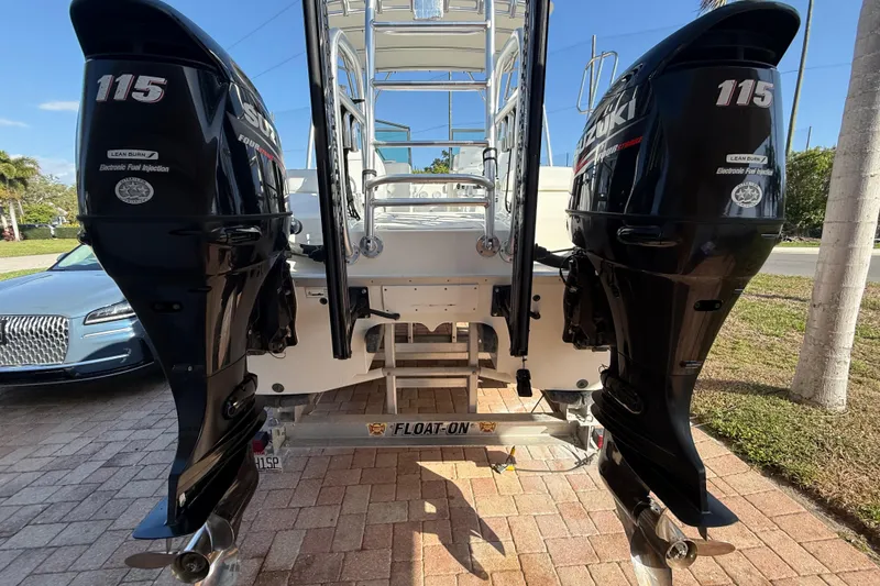 Slide: The Image of 2014 Carolina Cat 23DC with dual Suzuki 115 outboard motors on a trailer. - 6