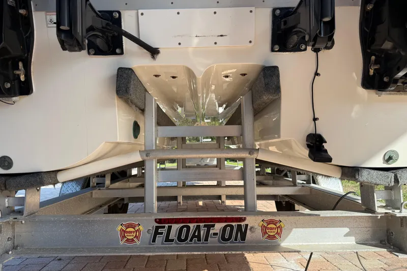 Slide: The Image of 2014 Carolina Cat 23DC boat on a Float-On trailer, rear view. - 61