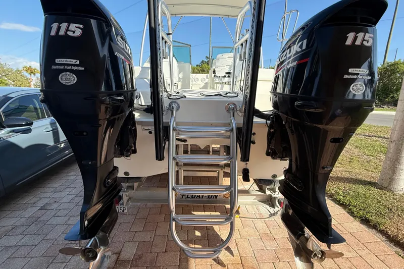 Slide: The Image of 2014 Carolina Cat 23DC boat with dual Suzuki 115 outboard motors. - 7