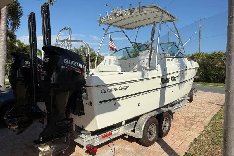 Slide: The Image of 2014 Carolina Cat 23DC boat on trailer with dual Suzuki outboard motors. - 8