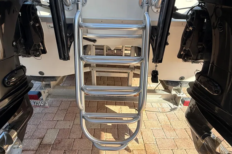 Slide: The Image of Stainless steel boat ladder on a 2014 Carolina Cat 23DC, between dual outboard motors. - 9
