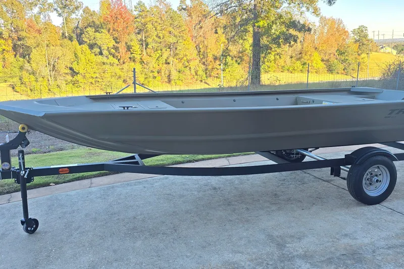 Slide: The Image of 2026 Tracker Grizzly 1648 Utility boat on trailer, set against a scenic autumn backdrop. - 4