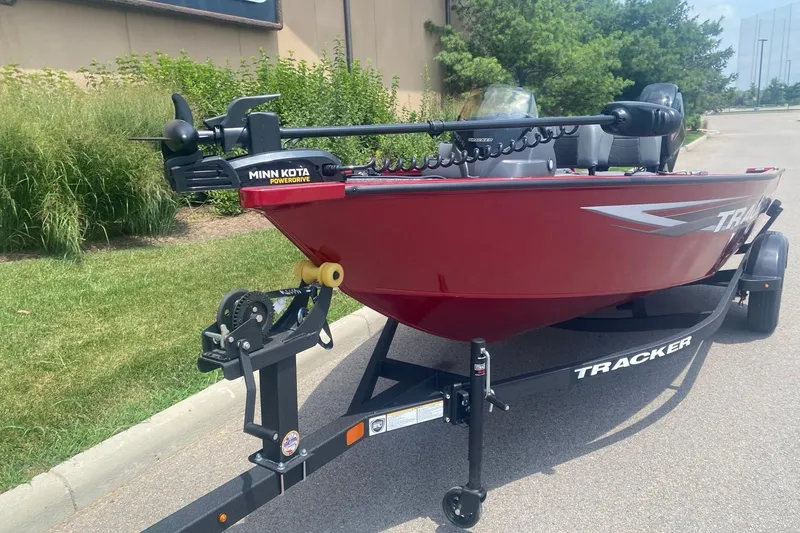 Slide: The Image of 2026 Tracker Super Guide V-16 SC boat with Minn Kota PowerDrive motor on trailer. - 2