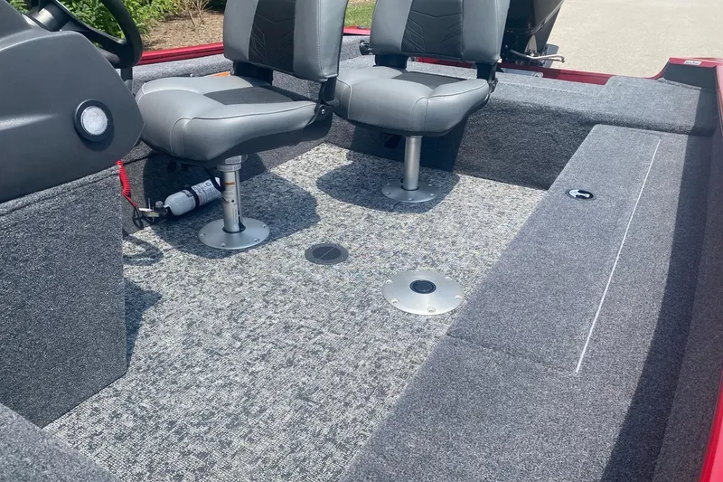 Slide: The Image of Interior of 2026 Tracker Super Guide V-16 SC boat with gray seating and carpeted flooring. - 3