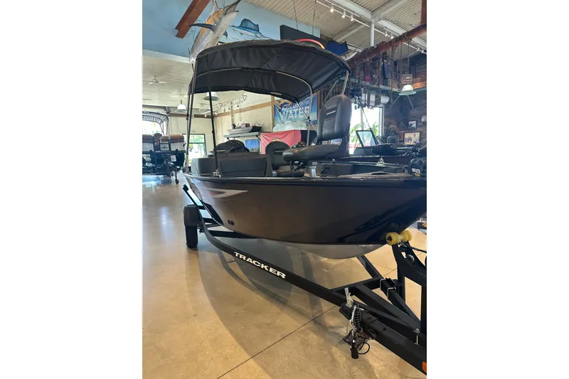 The Image of 2026 Tracker Pro Guide V-16 SC boat displayed indoors on a trailer. - 0
