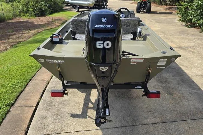 Slide: The Image of 2026 Tracker Grizzly 1754 SC boat with Mercury 60 engine on a driveway. - 3