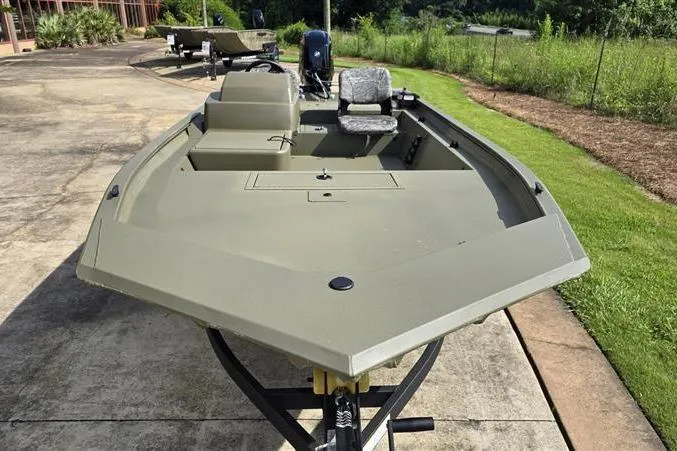 Slide: The Image of 2026 Tracker Grizzly 1754 SC boat on trailer, parked outdoors, showcasing spacious deck and seating. - 7