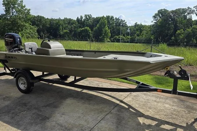 The Image of 2026 Tracker Grizzly 1754 SC boat on trailer, parked outdoors with lush greenery background. - 0