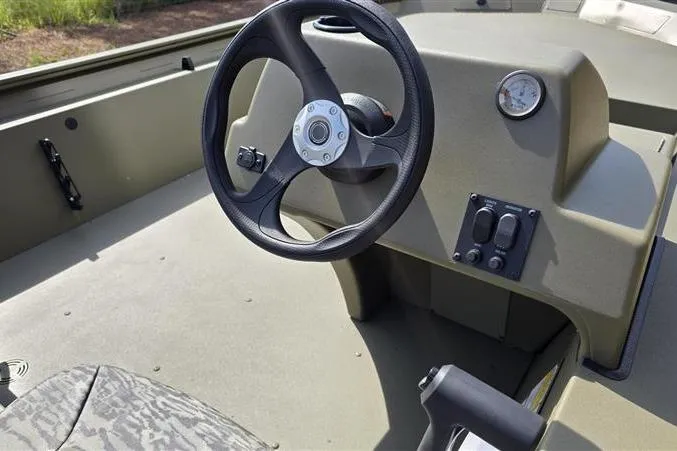 Slide: The Image of Steering console of 2026 Tracker Grizzly 1754 SC boat, featuring a simple dashboard design. - 4