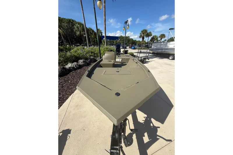 The Image of 2026 Tracker Grizzly 1648 SC boat displayed outdoors on a sunny day. - 0