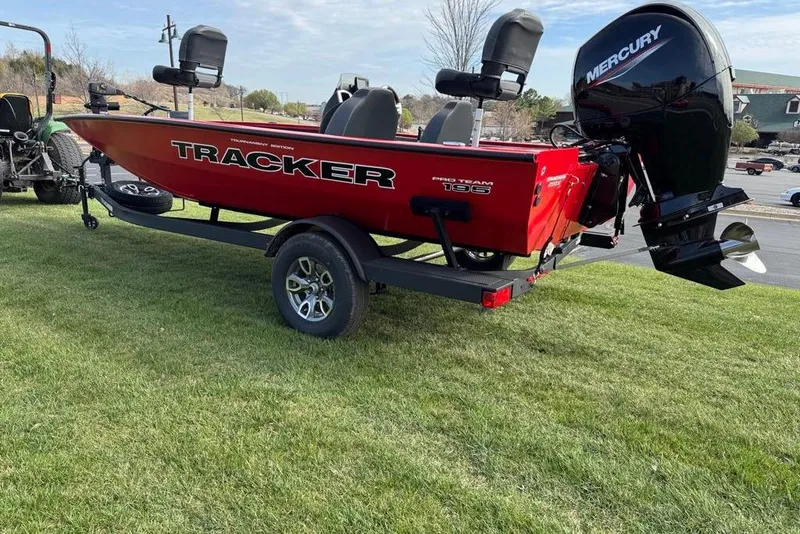 Slide: The Image of Red 2026 Tracker Pro Team 195 boat with Mercury engine on grassy area. - 5