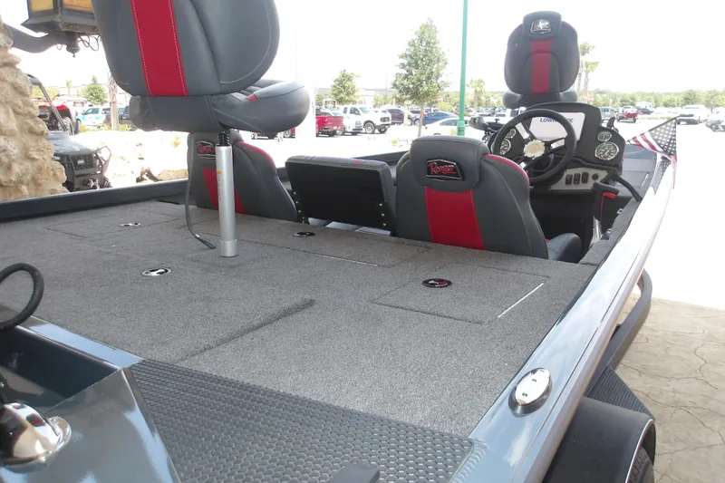 Slide: The Image of 2026 Ranger RT178 boat interior with gray and red seating, steering console, and deck storage. - 14
