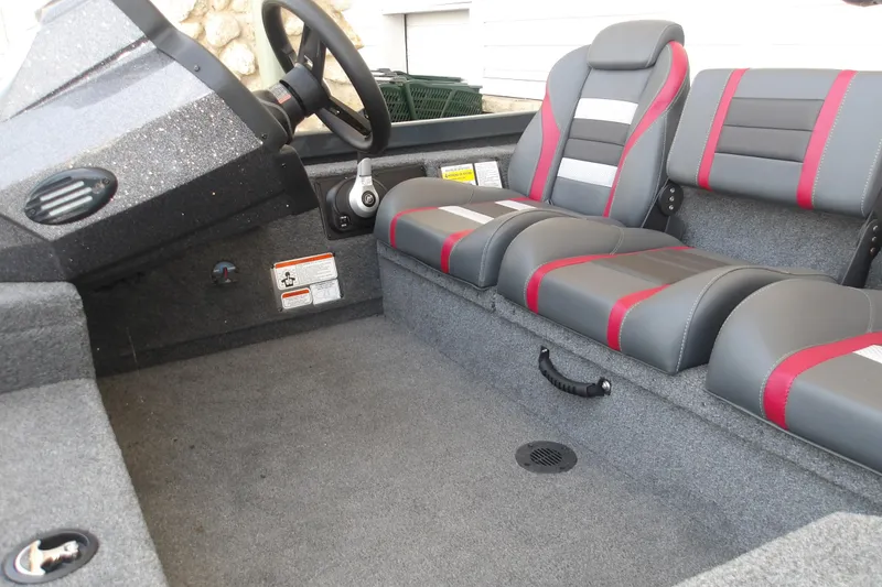 Slide: The Image of 2026 Ranger RT178 boat interior with gray and red seating, steering wheel, and carpeted floor. - 8
