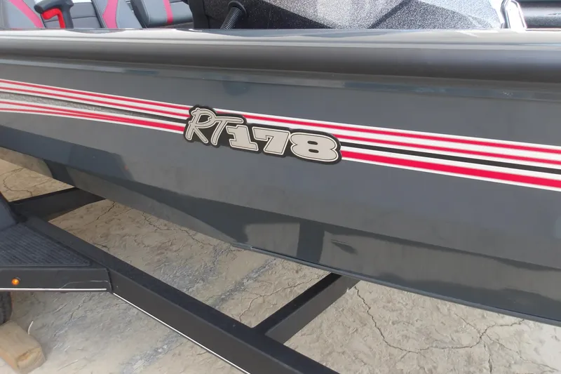 Slide: The Image of 2026 Ranger RT178 boat with red stripes on a trailer. - 11