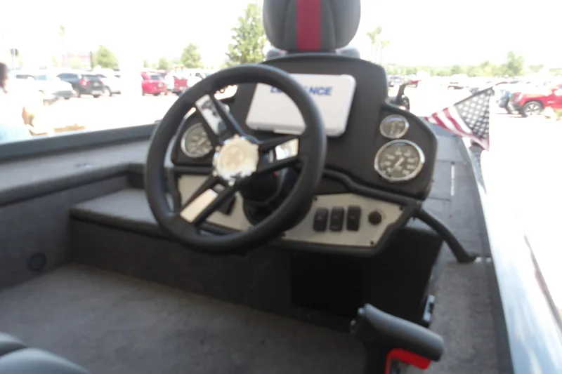 Slide: The Image of 2026 Ranger RT178 boat dashboard with steering wheel and gauges, featuring an American flag. - 15