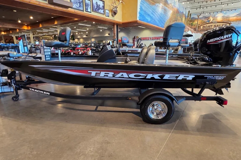 The Image of 2026 Tracker Pro Team 175 boat displayed in showroom with Mercury engine. - 0