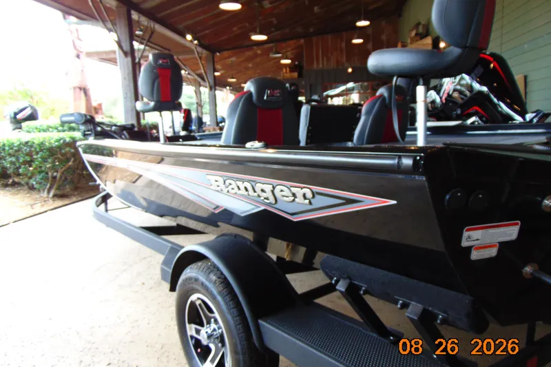 Slide: The Image of 2026 Ranger RT188P boat in showroom, featuring sleek black design and comfortable seating. - 11