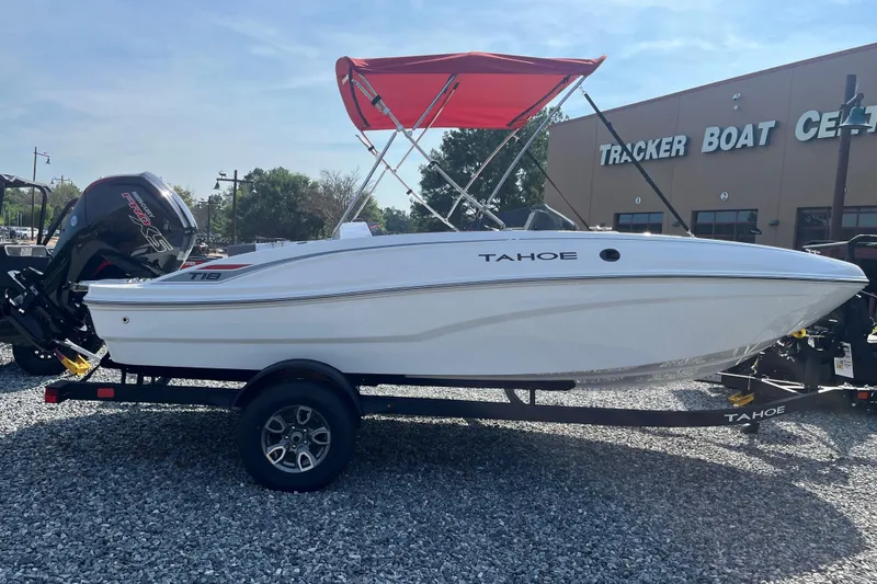 Slide: The Image of 2026 Tahoe T18 boat with red canopy on trailer at Tracker Boat Center. - 1